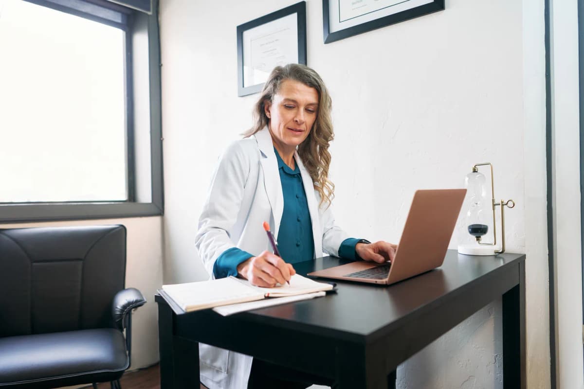 Female doctor working at her clinic on the computer